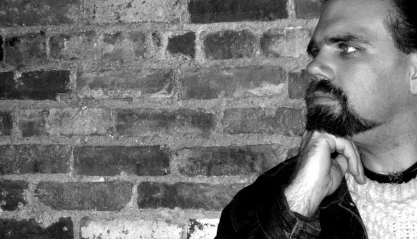 Chris Dowgin profile on brick wall